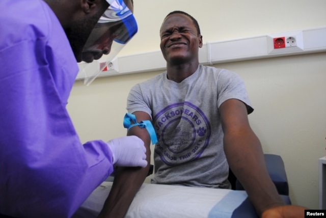 The blood of a survivor of the Ebola virus is extracted as part of a study launched at Liberia's John F. Kennedy Hospital in Monrovia, Liberia, June 17, 2015.