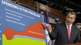 House Speaker John Boehner of Ohio points to a chart to emphasize his talking point that government spending complicates the negotiations on avoiding the so-called "fiscal cliff," during a news conference on Capitol Hill in Washington, Thursday, Dec. 13, 