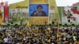 Pendukung pemimpin Hizbullah, Hassan Nasrallah, menonton tayangan pidatonya di Mashghara, Bekaa Valley, Lebanon (25/5). (AP/Hussein Malla)