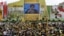Supporters of Hezbollah leader Hassan Nasrallah watch a broadcast of his speech in Mashghara, Bekaa Valley, Lebanon, May 25, 2013.