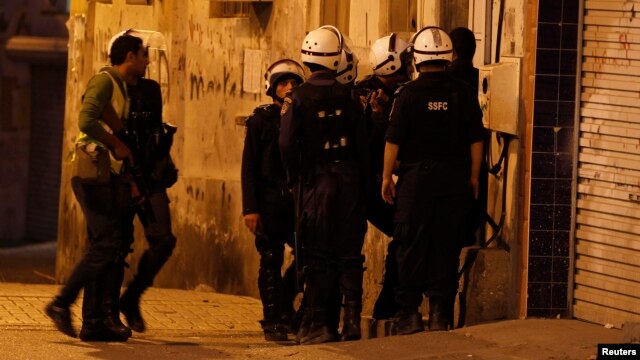 Bahraini riot police enter a house during a raid to arrest suspected protesters involved in clashes (file photo).