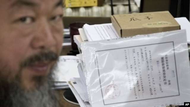 Artist Ai Weiwei with notice from city's Chaoyang District police that restrictions would expire Friday, Beijing, June 21, 2012.