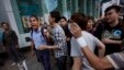A man shares his opposing views with pro-democracy student protesters in the Mong Kok district of  Hong Kong, Oct. 18, 2014. 