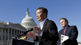 Rep. Chris Smith, R-N.J., right, listens as he and human rights activist Harry Wu, left, criticize the one-child rule in China, at the Capitol in Washington, Monday, March 7, 2011. 