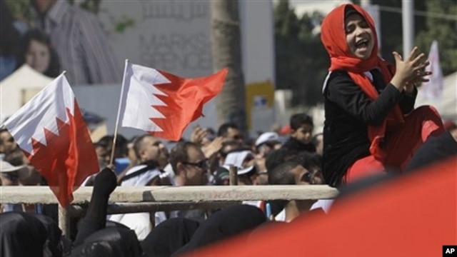 Bahraini anti-government protesters chant and wave Bahraini flags at the Pearl roundabout in Manama, Bahrain, Sunday, Feb. 20, 2011