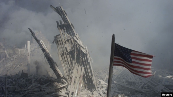 An American flag flies near the base of the destroyed World Trade Center in New York, in this file photo from September 11, 2001,