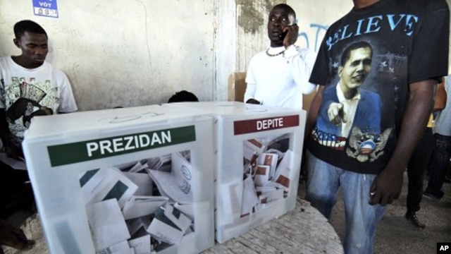 Man wearing t-shirt with U.S. President Barack Obama's face is seen inside of a polling center during presidential elections in Port-au-Prince, March 20, 2011