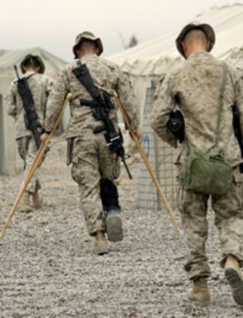 US Marines of the 1st Division walk to a briefing prior to a mission outside Fallujah, Iraq, November 1, 2004.