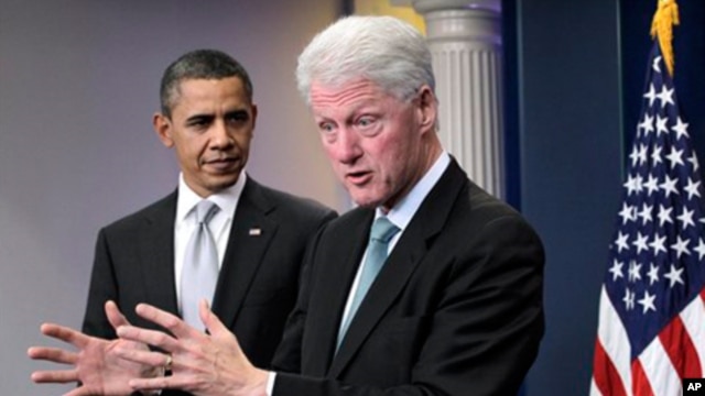 President Barack Obama looks on as former President Bill Clinton speaks in the briefing room of the White House in Washington, Friday, Dec. 10, 2010.
