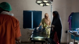 A nurse prepares the operating table for surgery, Ras Kamboni, Somalia, July 6, 2012. (VOA - R. Gogineni)