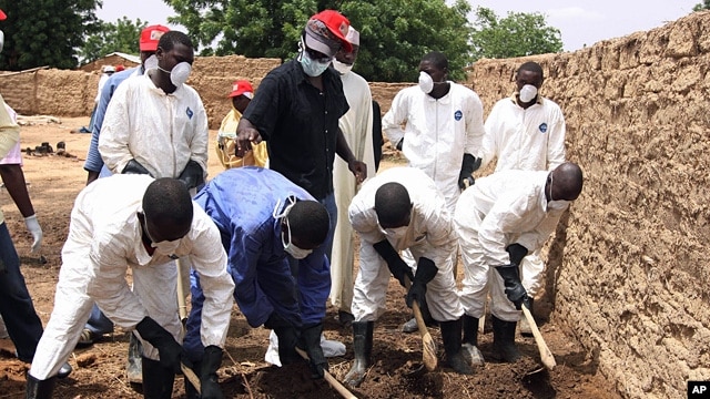 Health workers remove earth contaminated by lead from a family compound in the village of Dareta in Gusau, Nigeria, June 10, 2010.