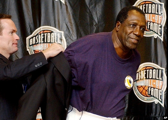 FILE - Basketball Hall of Fame CEO John Doleva, left, presents a Hall of Fame jacket to inductee Meadowlark Lemon, of the Harlem Globetrotters, at the Basketball Hall of Fame in Springfield, Massachusetts, Sept. 5, 2003.