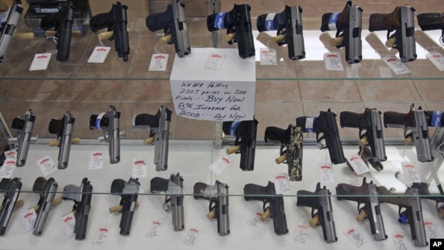 Handguns are on display at B & J Guns in Colonie, New York, June 26, 2008.  The Supreme Court ruled that Americans have a constitutional right to keep guns in their homes for self-defense, the justices' first major pronouncement on gun control in U.S. his