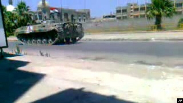 Image taken from video footage uploaded on YouTube shows a Syrian army tank deployed in a main street in the Khalidiya area of the protest hub of Homs, 160 kilometers north of Damascus, on August 17, 2011.