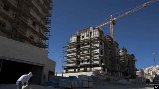 A construction worker works at a site of a new housing unit in the east Jerusalem neighborhood of Har Homa, Wednesday, Nov. 2, 2011.