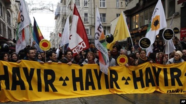 Activists march during a protest against the Turkish government's plans to build a nuclear power plant in the country in Istanbul March 19, 2011.  The banner reads, "No no no."