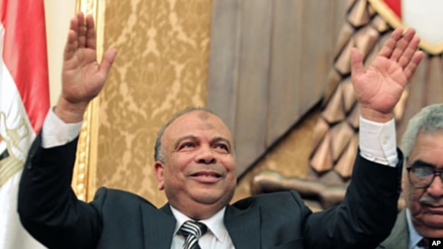 Newly elected speaker of the Egyptian parliament, Saad el-Katatni of the Muslim Brotherhood, salutes during the first session of the newly-elected assembly in Cairo, January 23, 2012