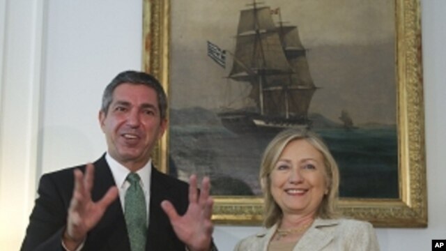 Greek Foreign Minister Stavros Lambrinidis , left, and US Secretary of State Hillary Rodham Clinton speak on Sunday July 17, 2011 during a meeting at the Ministry of Foreign Affairs in Athens