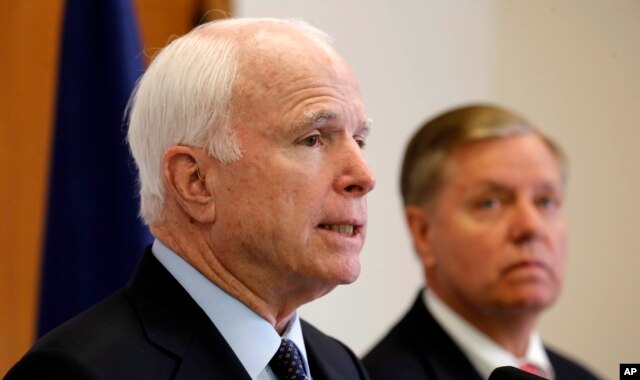 FILE - Republican presidential candidate Sen. Lindsey Graham, R-S.C. listens at right as former Republican presidential nominee, Sen. John McCain, R-Ariz. talks about his support for Graham during a campaign stop, Friday, Sept. 11, 2015, in Manchester, N