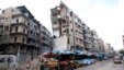 FILE - Stalls are seen on a street beside damaged buildings in the rebel held al-Shaar neighborhood of Aleppo, Syria, Feb. 10, 2016. 