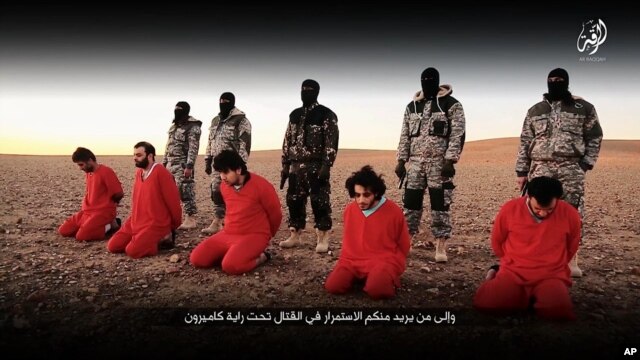 This undated image, taken from video posted online Jan. 3, 2016, by the communications arm of the Islamic State group, purports to show IS militants executing five men who they accuse of having spied for Britain in Syria.