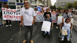 Disabled Greeks march during a rally against new austerity measures, in central Athens, September 12, 2012.