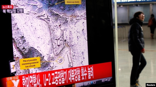 A passenger walks past a television report on North Korea's nuclear test at a railway station in Seoul February 12, 2013.