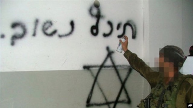 A handout picture obtained by AFP from the Israeli human rights organization Breaking the Silence on 25 October 2010 allegedly shows an Israeli soldier spray-painting a Star of David and the Hebrew writing "Back soon" on what appears to be the wall of a h