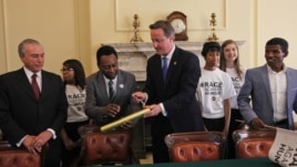 From left to right: Brazilian Vice President Michel Temer, former Brazilian football star Pele, British Prime Minister David Cameron and Ethiopian running legend Haile Gebreselassie gather for a 'Race Against Hunger' photo call at 10 Downing in London Sun