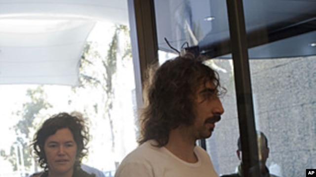 Freed American freelance journalist Clare Morgana Gillis, left and Spanish photographer Manu Brabo arrive to a hotel where most of international media stays in Tripoli, Libya, May 18, 2011.