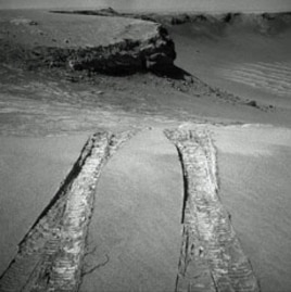 NASA's Mars Exploration Rover Opportunity climbed out of "Victoria Crater" following the tracks it had made when it descended into the 800-meter-diameter (half-mile-diameter) bowl nearly a year earlier.