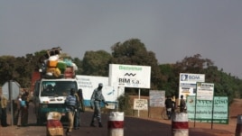 A public transport minibus is stopped by Malian soldiers at a checkpoint at the entrance to Markala, approximately 40 km outside Segou on the road to Diabaly, in central Mali, Jan. 14, 2013.