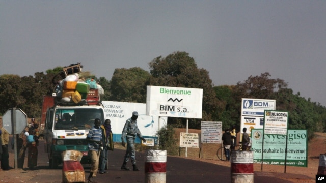 A public transport minibus is stopped by Malian soldiers at a checkpoint at the entrance to Markala, approximately 40 km outside Segou on the road to Diabaly, in central Mali, Jan. 14, 2013.