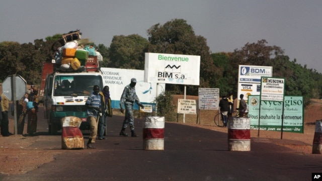 A public transport minibus is stopped by Malian soldiers at a checkpoint at the entrance to Markala, approximately 40 km outside Segou on the road to Diabaly, in central Mali, Jan. 14, 2013.