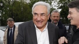 Former IMF head Dominique Strauss-Kahn (C) and Deputy Mayor of Sarcelles Francois Pupponi (2nd R), arrive at a polling station in the second round of the 2012 French presidential elections in Sarcelles, May 6, 2012.