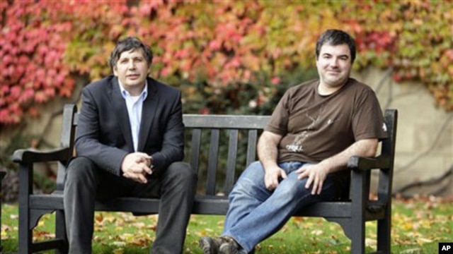 Professor Andre Geim, left, and Dr. Konstantin Novoselov, who have been awarded the Nobel Prize for Physics, pose for pictures outside Manchester University, Manchester, England,  05 Oct 2010