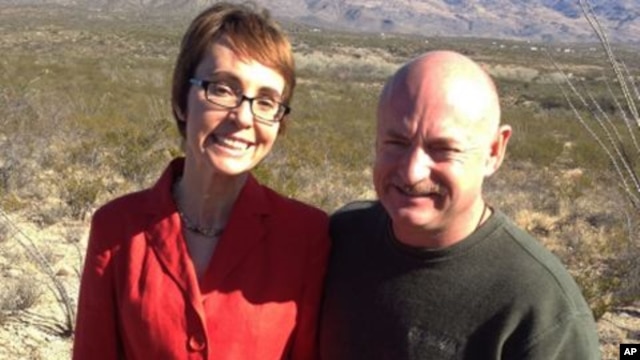 In this photo provided by the office of U.S. Rep. Gabrielle Giffords, Giffords and husband Mark Kelly pose at the Davidson Canyon Gabe Zimmerman Memorial outside of Tucson, Arizona, January 7, 2012.