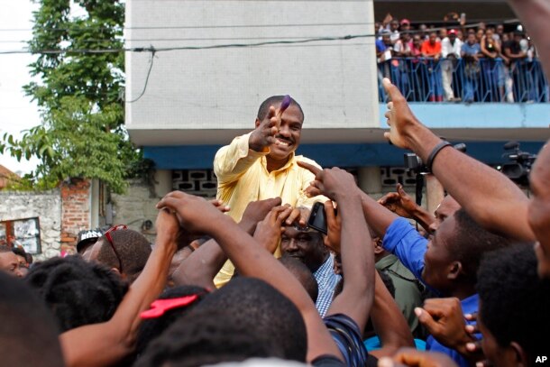 Presidential candidate Jude Celestin, from the LAPEH party, greets supporters after voting in the Petion-Ville suburb of Port-au-Prince, Haiti, Nov. 20, 2016.