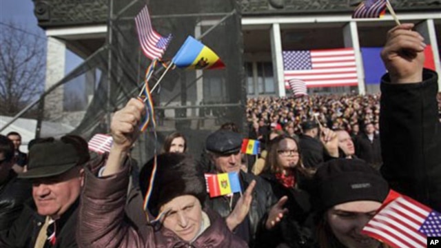 Moldovans wave American flags as US Vice President Joseph Biden speaks to several thousand people on a central square in Chisinau, Moldova, March 11, 2011