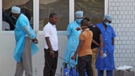 Medical personnel at emergency entrance of hospital receive suspected Ebola virus patients, Conakry, Guinea, March 29, 2014.