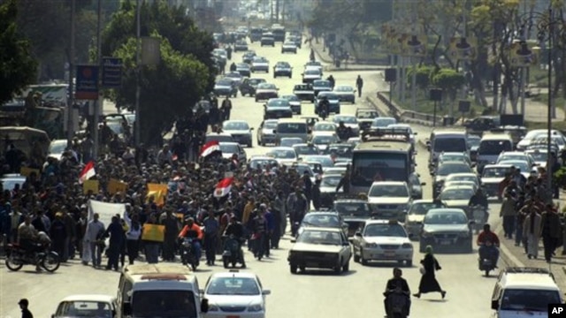 Anti-government protesters march in a street in Cairo, Egypt, Feb 11, 2011