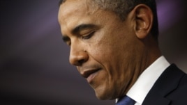 U.S. President Barack Obama looks at his notes during remarks to reporters after meeting with congressional leaders at the White House in Washington, December 28, 2012.