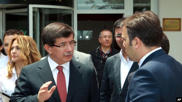 Turkish Foreign Minister Ahmet Davutoglu talking to an adviser, in Ankara, June 24, 2012, in this image made available by the Turkish Foreign Ministry. 
