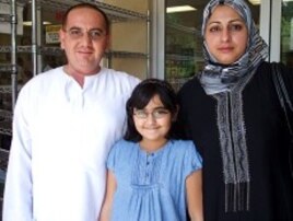 Iraqi Wisam Alani, his wife and their nine-year-old daughter attend midday prayer service at the ADAMS center mosque, 13 Aug 2010