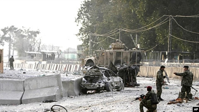 Afghan soldiers secure the scene of a suicide attack at the gate of an airport in Jalalabad, Nangarhar province east of Kabul, Afghanistan, February 27, 2012.