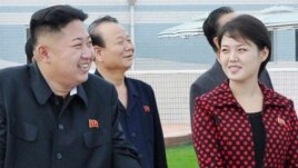 North Korean leader Kim Jong Un (2nd L) and a woman being identified by state TV as his wife 'Comrade Ri Sol Chu,' visit the Rungna People's Pleasure Ground, which is nearing completion, in Pyongyang, July 25, 2012.
