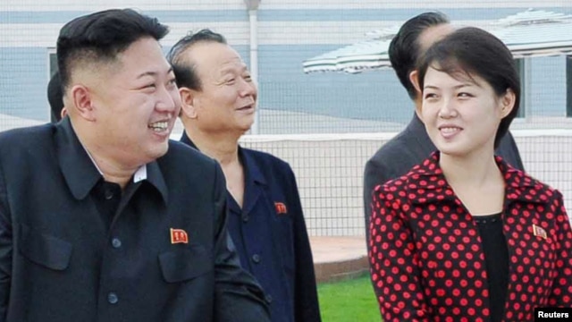 North Korean leader Kim Jong Un (2nd L) and a woman being identified by state TV as his wife 'Comrade Ri Sol Chu,' visit the Rungna People's Pleasure Ground, which is nearing completion, in Pyongyang, July 25, 2012.