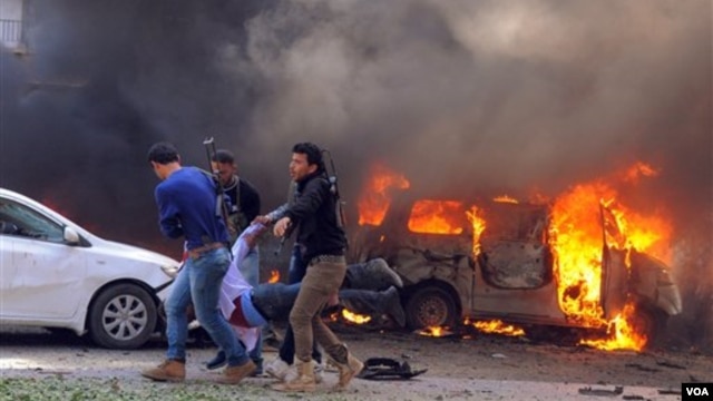 cho thấy Syria mang theo một người đàn ông Người bị thương được khiêng ra khỏi hiện trường sau vụ đánh bom gần trụ sở của đảng Ba'ath cầm quyền Syria ở trung tâm Damascus, ngày 21/2/2013.