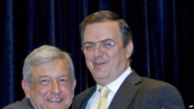 Mexico's former presidential candidate Manuel Lopez Obrador (l) embraces Mexico City Mayor Marcelo Ebrard in Mexico City, Nov. 15,  2011.