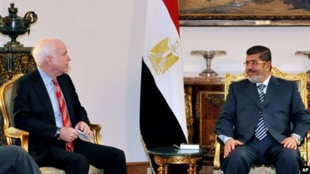 Egyptian President Mohammed Morsi, right, meets with Republican Sen. John McCain, presidential palace, Cairo, Jan. 16, 2013.